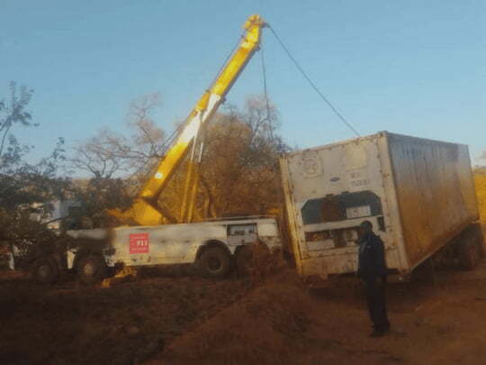 Shipping container being rigged and recovered by 911 in the DRC