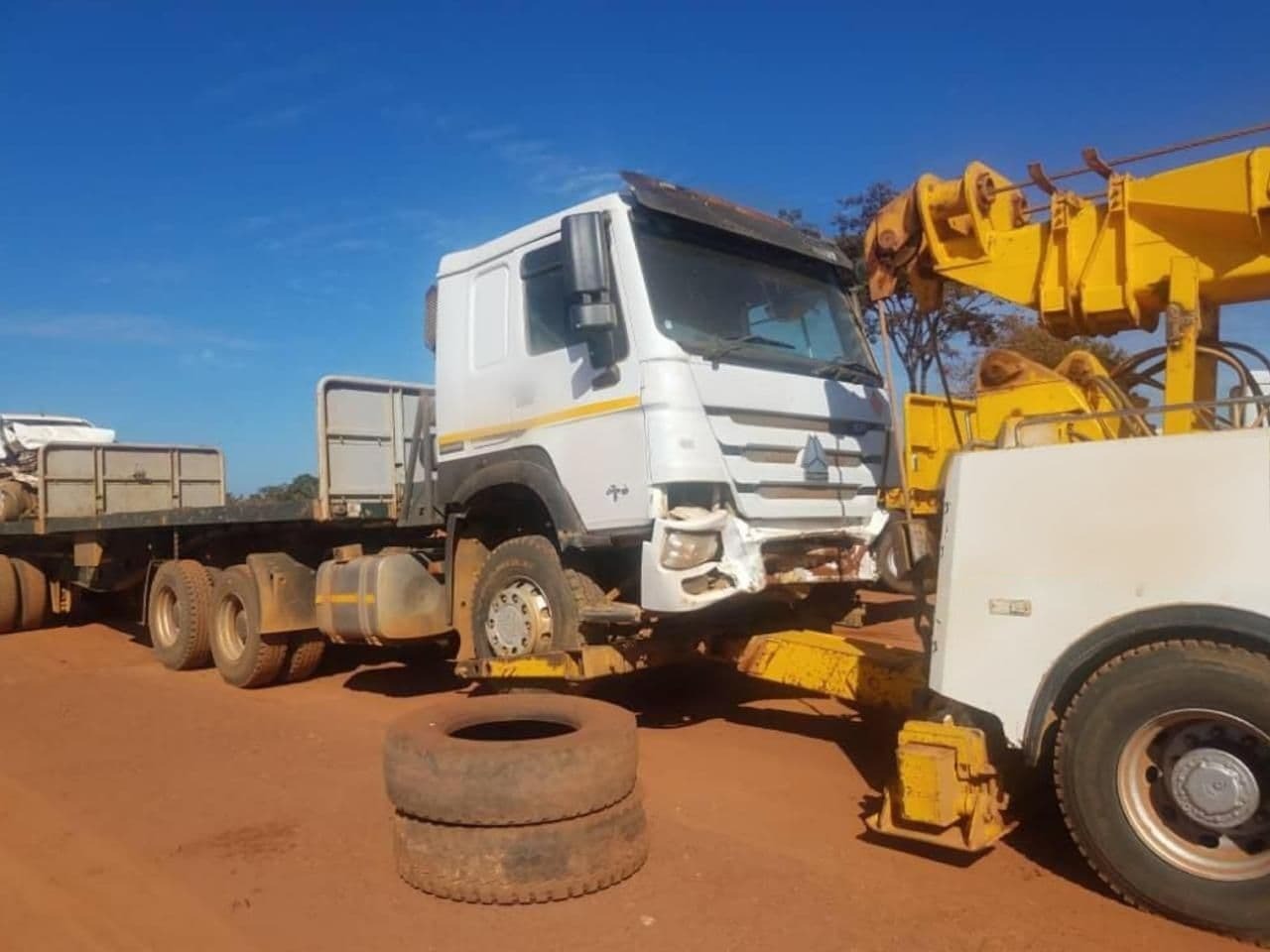 Heavy-duty vehicle being towed by 911 on a DRC road